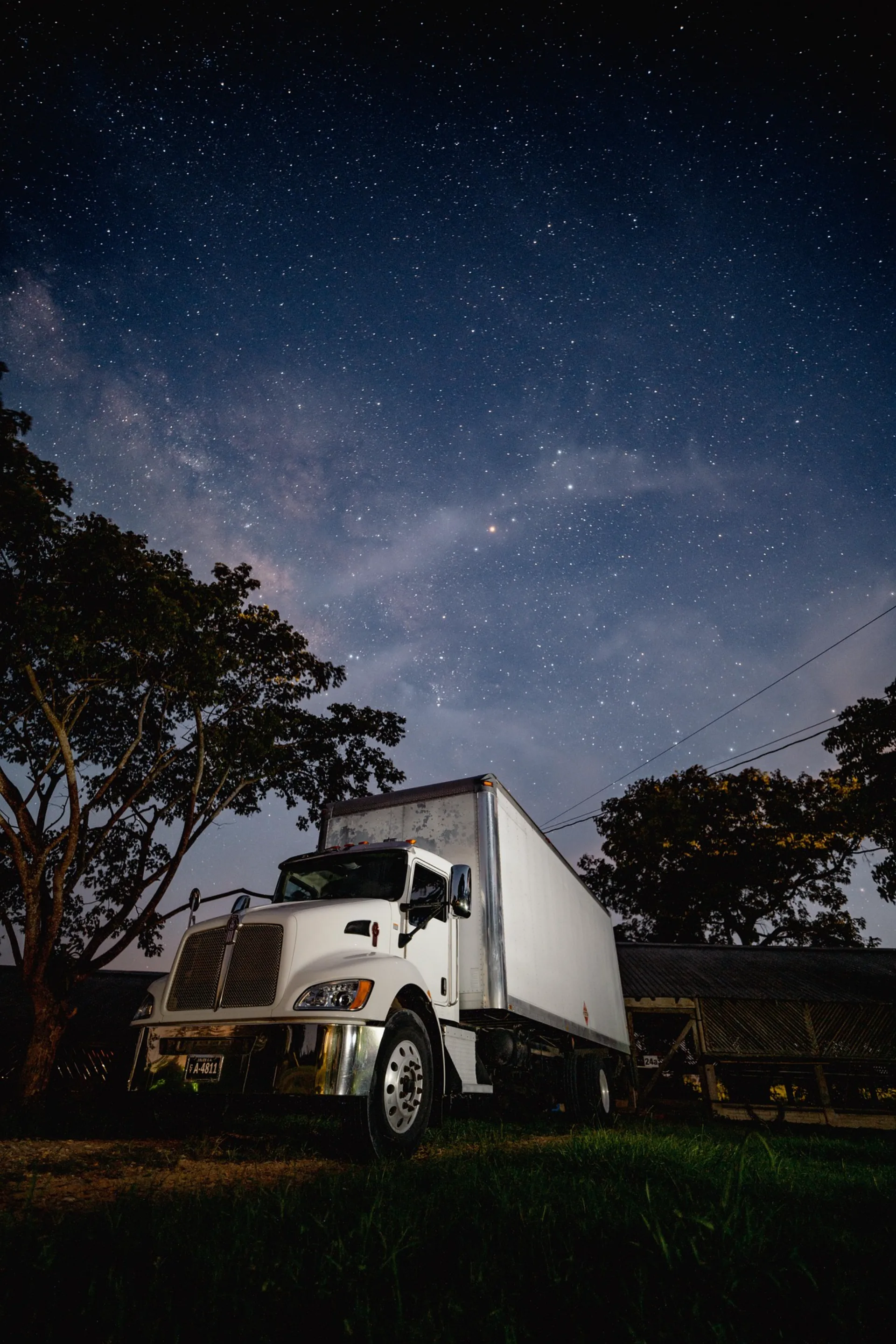 Eric Logistics box truck parked under a starry night sky